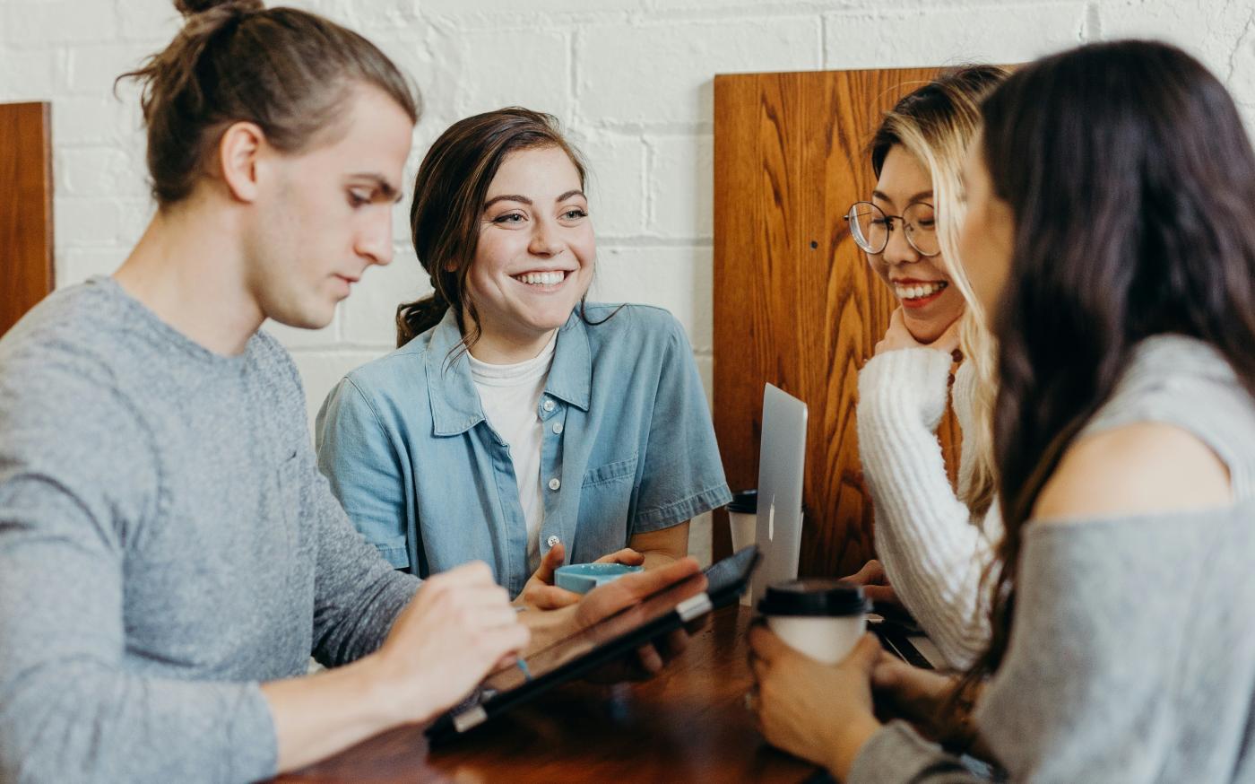 A group of friends at a coffee shop by Brooke Cagle courtesy of Unsplash.