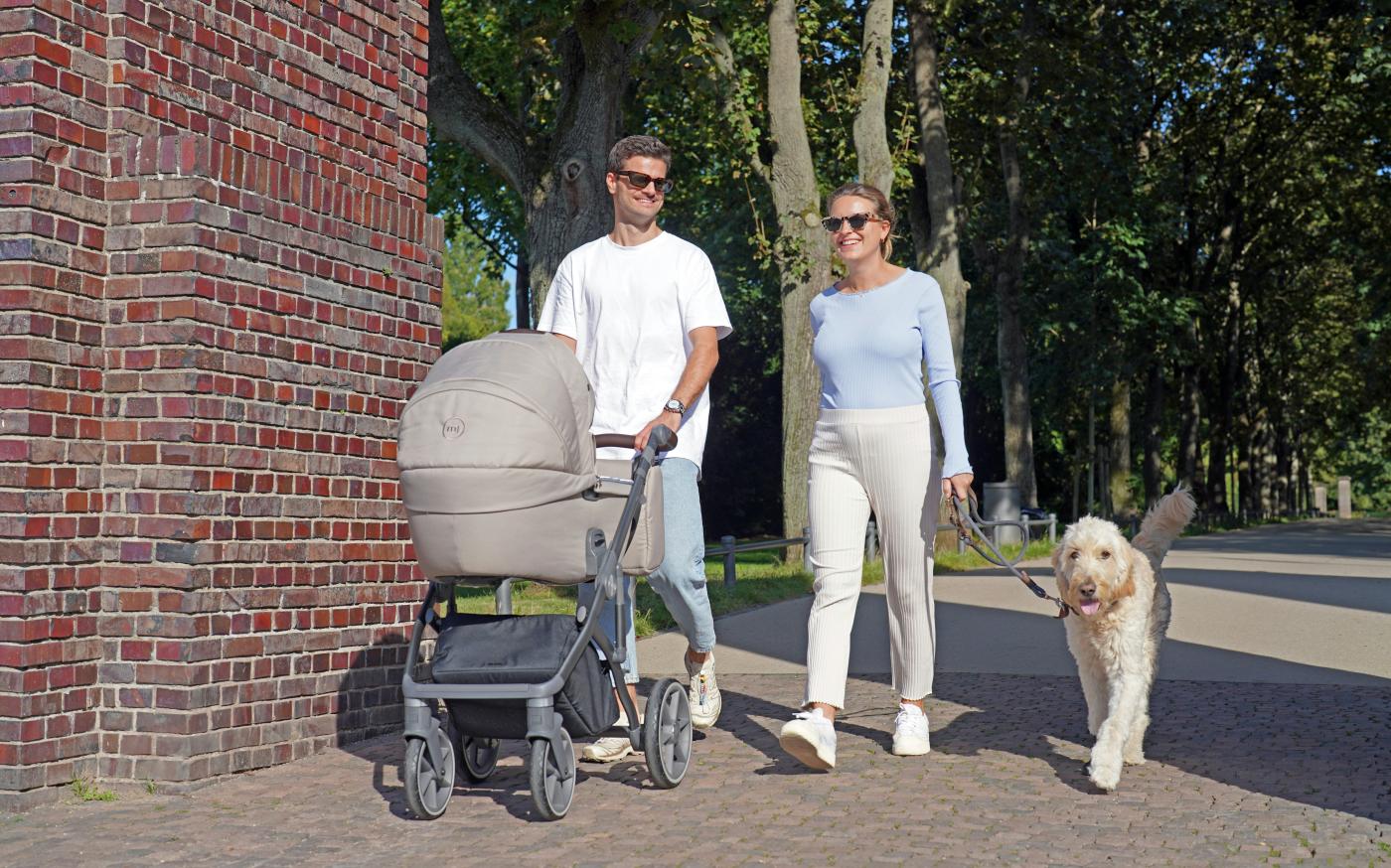 a man and a woman walking a dog and a stroller by Frederik Rosar courtesy of Unsplash.