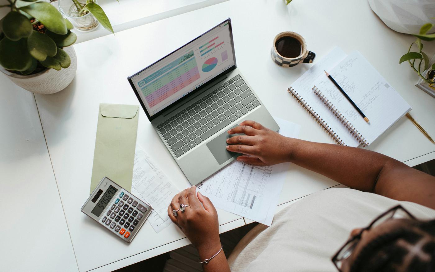 a person sitting at a table with a laptop by Microsoft 365 courtesy of Unsplash.