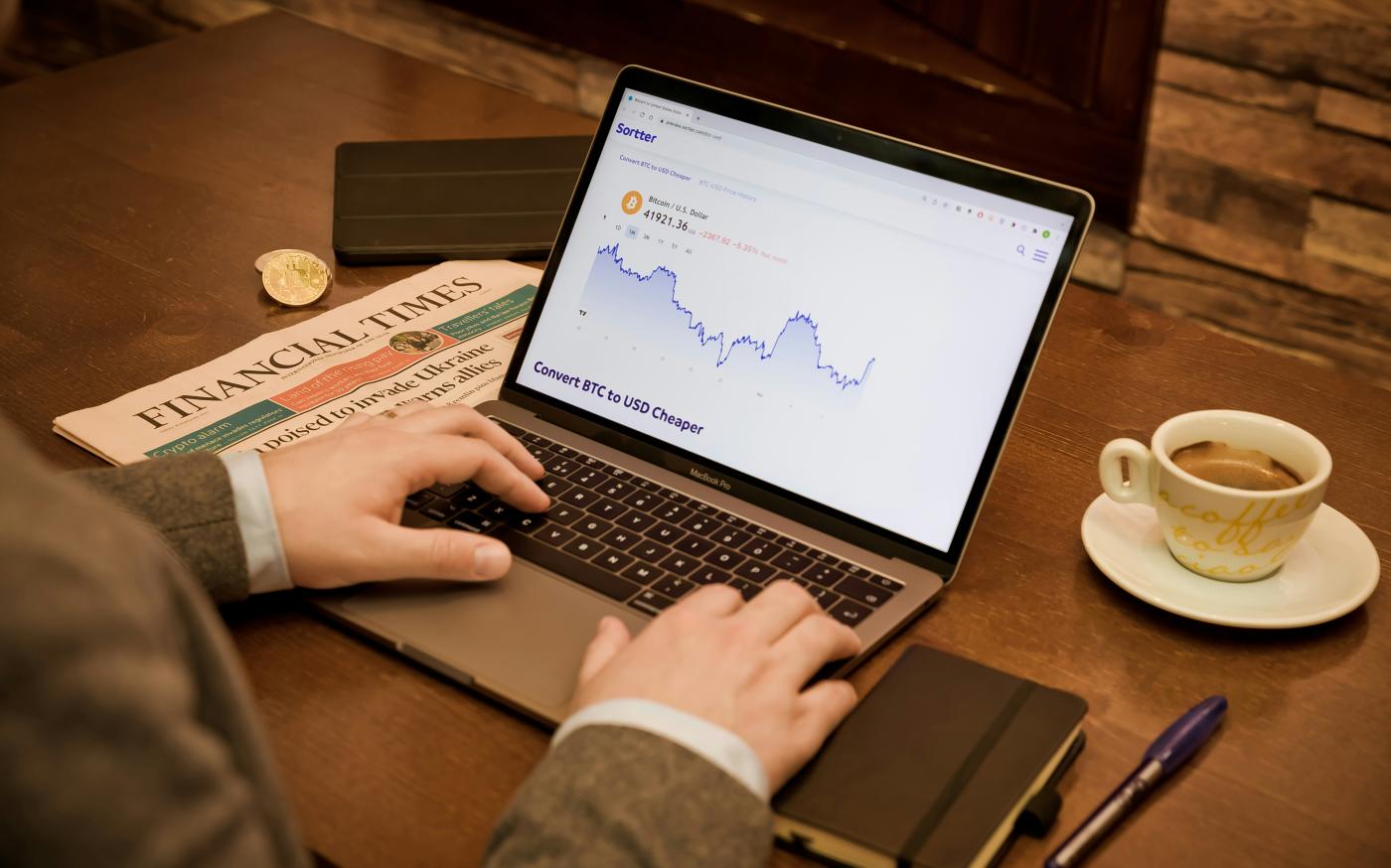 a person typing on a laptop on a table by Sortter courtesy of Unsplash.