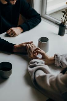 person in black long sleeve shirt holding white ceramic mug by Priscilla Du Preez 🇨🇦 courtesy of Unsplash.