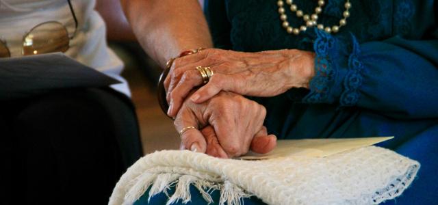 person wearing gold ring and blue dress by Manny Becerra courtesy of Unsplash.