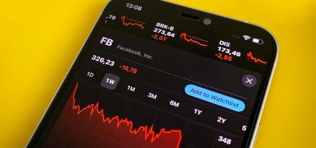 a cell phone with a chart on the screen by Hakan Nural courtesy of Unsplash.