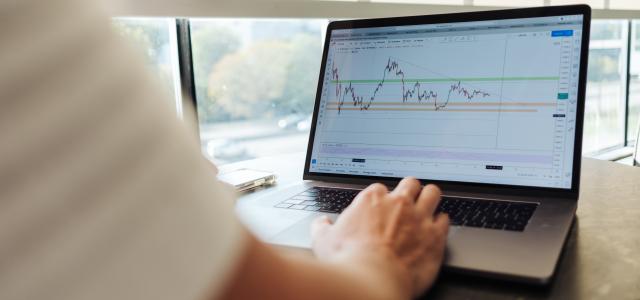 person using MacBook Pro on table by Jason Briscoe courtesy of Unsplash.