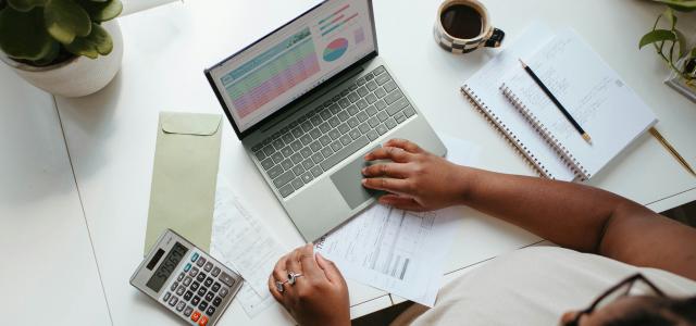 a person sitting at a table with a laptop by Microsoft 365 courtesy of Unsplash.